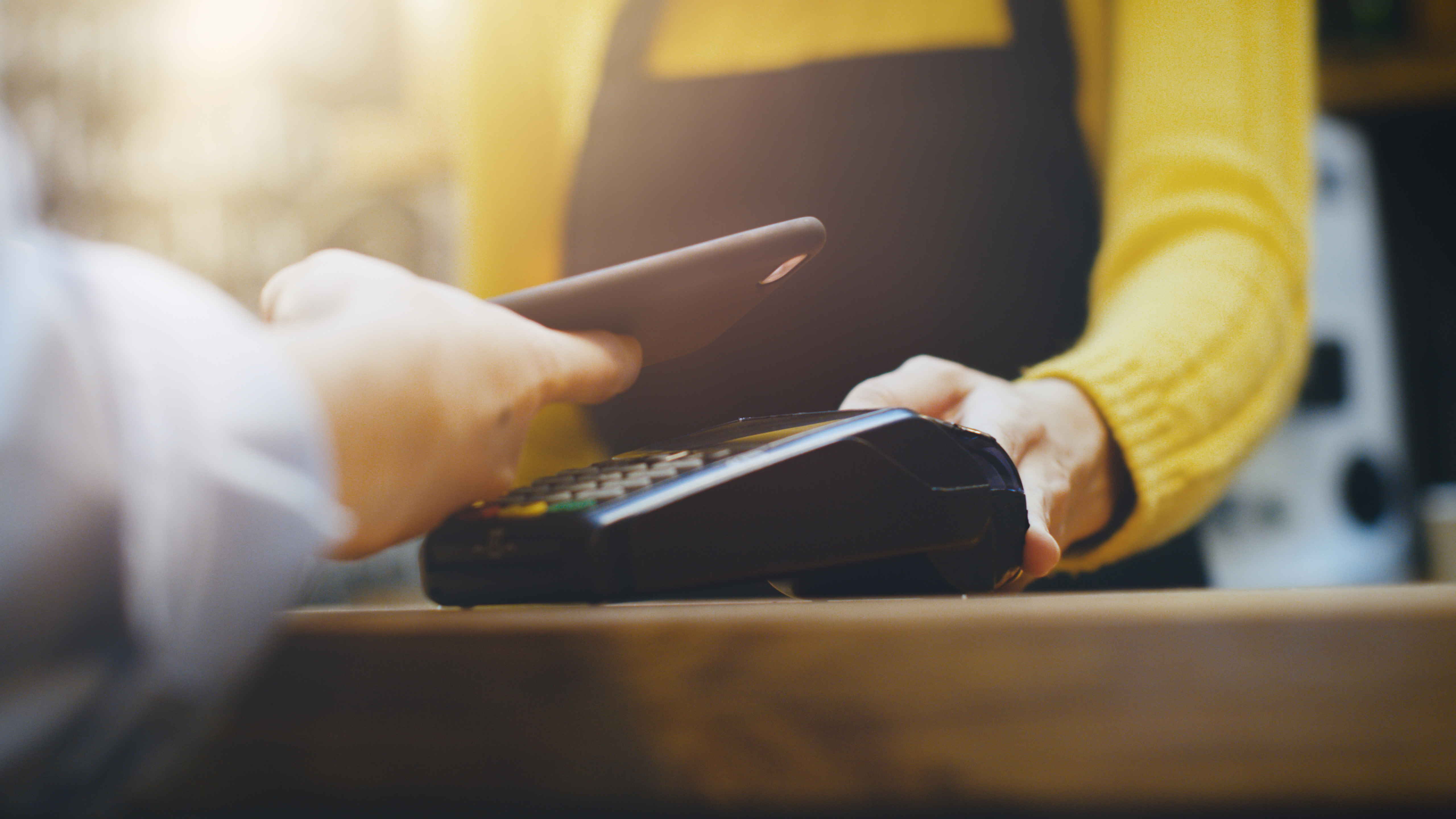 using smartphone to pay at retailer